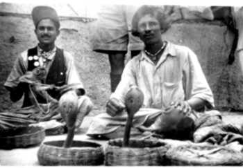 Photograph of a snake charmer in action in Poona in 1945